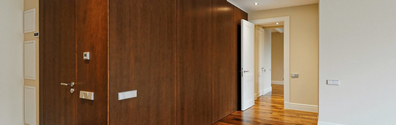 Wooden doors in panelled walls